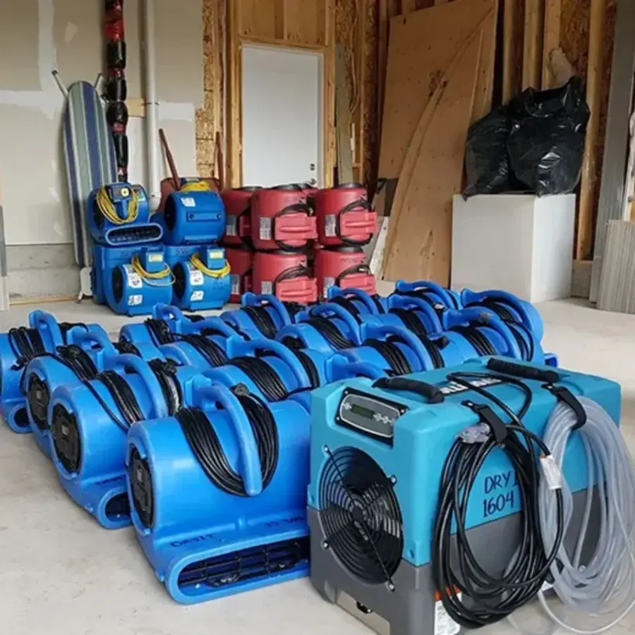 Air movers and dehumidifiers lined up in an opened room for structural drying, Granada Hills water damage restoration