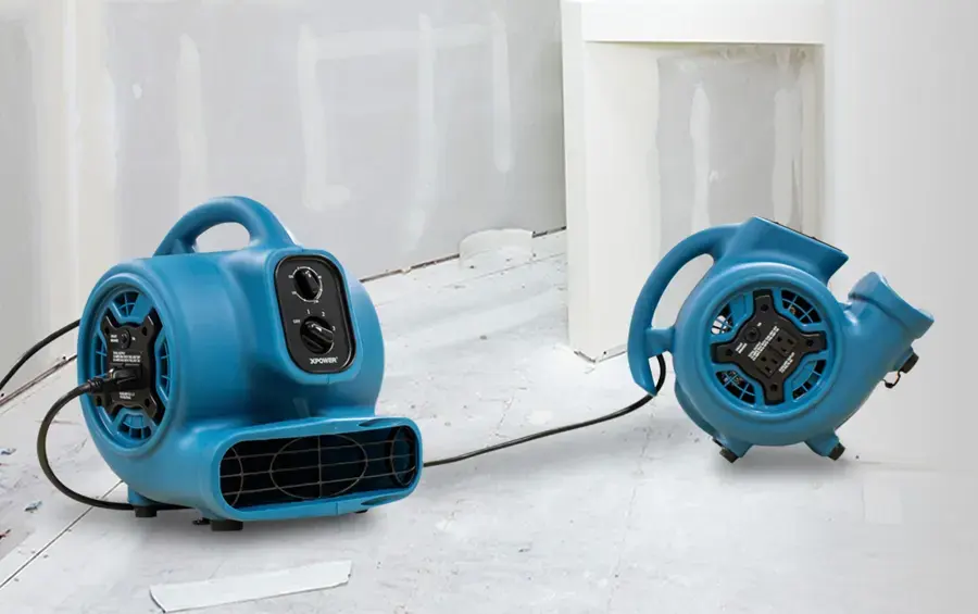 Two air movers blowing across the floor of a room opened up for drying in a Glendale, CA home.