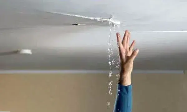 Water pouring through a crack in a ceiling, Granada Hills ceiling leak water damage